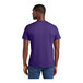 A man wearing a District purple short sleeve t-shirt.