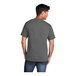A man wearing a Port & Company unisex charcoal short sleeve t-shirt.