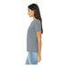 A woman wearing a Bella + Canvas women's grey customizable short sleeve t-shirt.