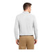 A man wearing a white Port Authority long sleeve polo shirt.