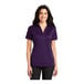 A woman wearing a purple Port Authority polo shirt.