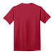 A close-up of a red Port & Company T-shirt with a white logo on the front.