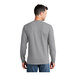 A man wearing a Port & Company athletic heather grey long sleeve shirt.