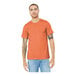 A man wearing an extra large Bella + Canvas heather orange t-shirt.
