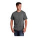 A man smiling and wearing a Port & Company graphite heather short sleeve t-shirt.