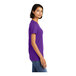 A woman wearing a purple District short sleeve t-shirt.