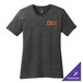 A dark heather grey Port & Company women's t-shirt with orange text on the table.