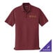 A burgundy Port Authority polo shirt with a logo on it.