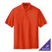 A medium orange Port Authority polo shirt with a green and white logo.