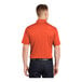 A man wearing a deep orange Sport-Tek polo shirt.