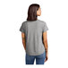 A back view of a woman wearing a customizable grey AllMade short sleeve t-shirt.