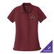 A maroon Port Authority polo shirt with a green logo on it.