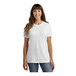 A woman wearing a white Port & Company v-neck t-shirt.