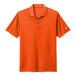 A brilliant orange Nike Dri-Fit polo shirt with a white Nike logo on the sleeve.
