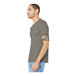 A man wearing a Bella + Canvas heather stone short sleeve t-shirt.
