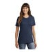 A woman wearing a navy Port & Company short sleeve t-shirt.