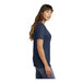 A woman wearing a navy Port & Company short sleeve t-shirt.