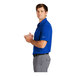 A man in a Nike blue dri-fit polo shirt.