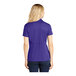 A woman wearing a purple Sport-Tek short sleeve polo shirt.