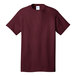 A maroon Port & Company T-shirt with a white collar.