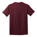 A close-up of a maroon Port & Company short sleeve t-shirt.