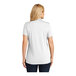 A woman wearing a white Port Authority Dry Zone short sleeve polo shirt.