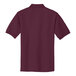 A close-up of a Port Authority maroon polo shirt.