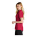 A woman wearing a red Nike polo shirt.