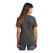 A woman wearing a charcoal Port & Company short sleeve t-shirt.