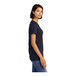 A woman wearing a navy blue District short sleeve t-shirt.