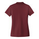 A Port Authority women's burgundy short sleeve polo shirt.