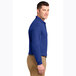 A man wearing a Port Authority® royal blue long sleeve polo shirt.
