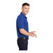 A man wearing a true royal blue Sport-Tek short sleeve polo.