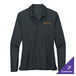 A Nike women's black long sleeve polo shirt on a table with gold embroidery.