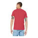A man wearing a customizable Bella + Canvas heather red t-shirt.