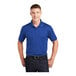 A man wearing a Sport-Tek True Royal short sleeve polo shirt.