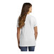 A woman with long hair in a white Port & Company short sleeve t-shirt.
