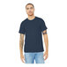 A man wearing a Bella + Canvas heather navy blue t-shirt and jeans.