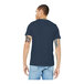 A man wearing a heather navy Bella + Canvas customizable t-shirt.