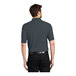 A man wearing a steel gray Port Authority pique polo shirt.