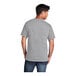 A man wearing a Port & Company athletic heather grey T-shirt.