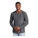 A man wearing a heathered charcoal long sleeve T-shirt.