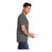 A man wearing a Port & Company charcoal short sleeve t-shirt.