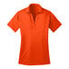 An extra large women's neon orange Port Authority polo shirt with a collar and short sleeves.