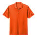 A brilliant orange Nike polo shirt with a white Nike swoosh on the sleeve.