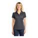 A woman wearing a grey Sport-Tek short sleeve performance polo shirt.