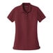 A Port Authority burgundy short sleeve polo shirt for women.