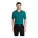 A man wearing a teal green Port Authority® Silk Touch™ Pique Polo shirt.