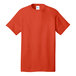 A close-up of an orange Port & Company short sleeve T-shirt.