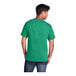 A man wearing a Port & Company Kelly green short sleeve T-shirt.
